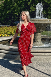 a lady in a red v-neck dress with white polka dots